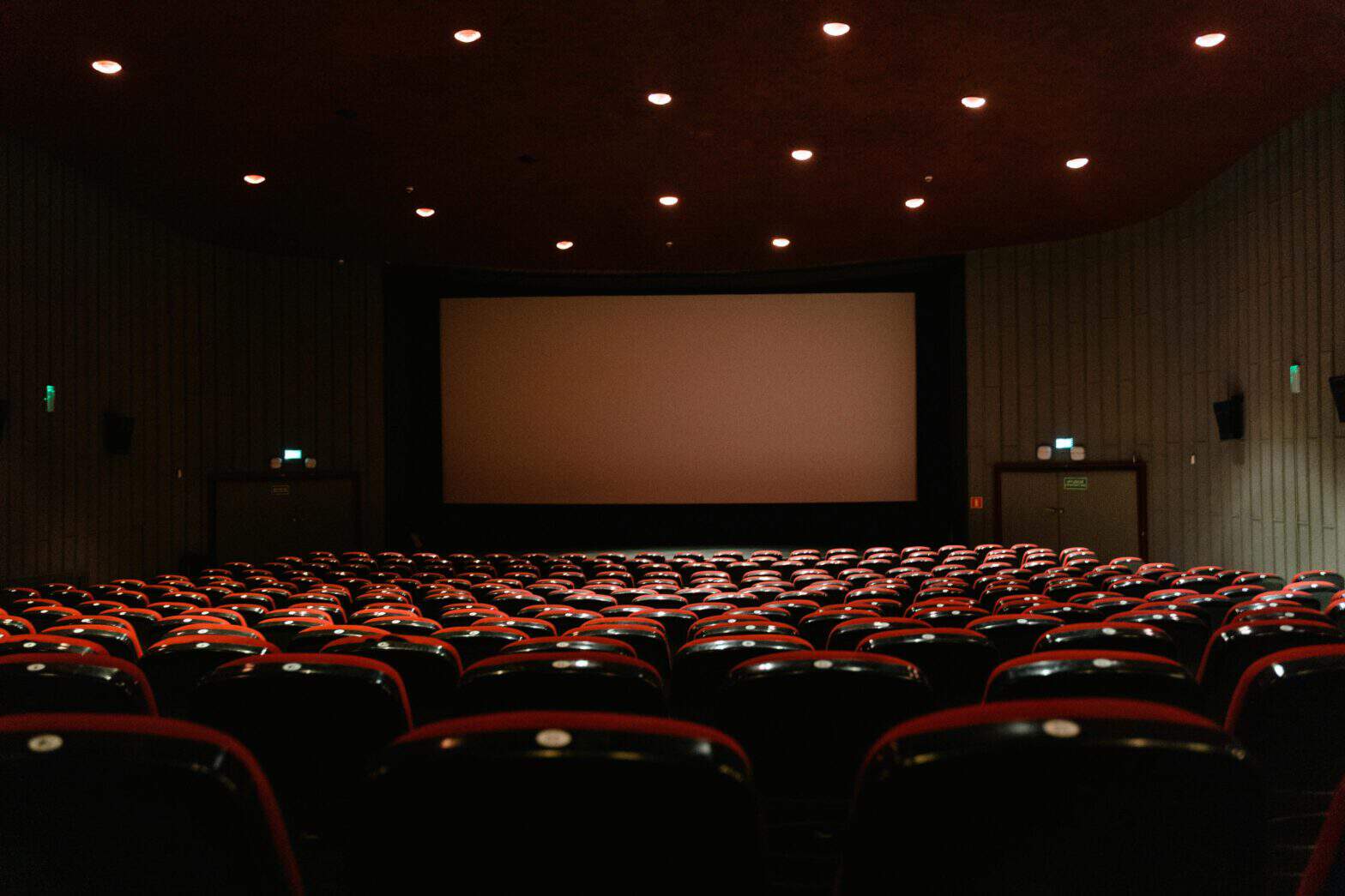 a cinema screen and rows of red chairs in Dubai