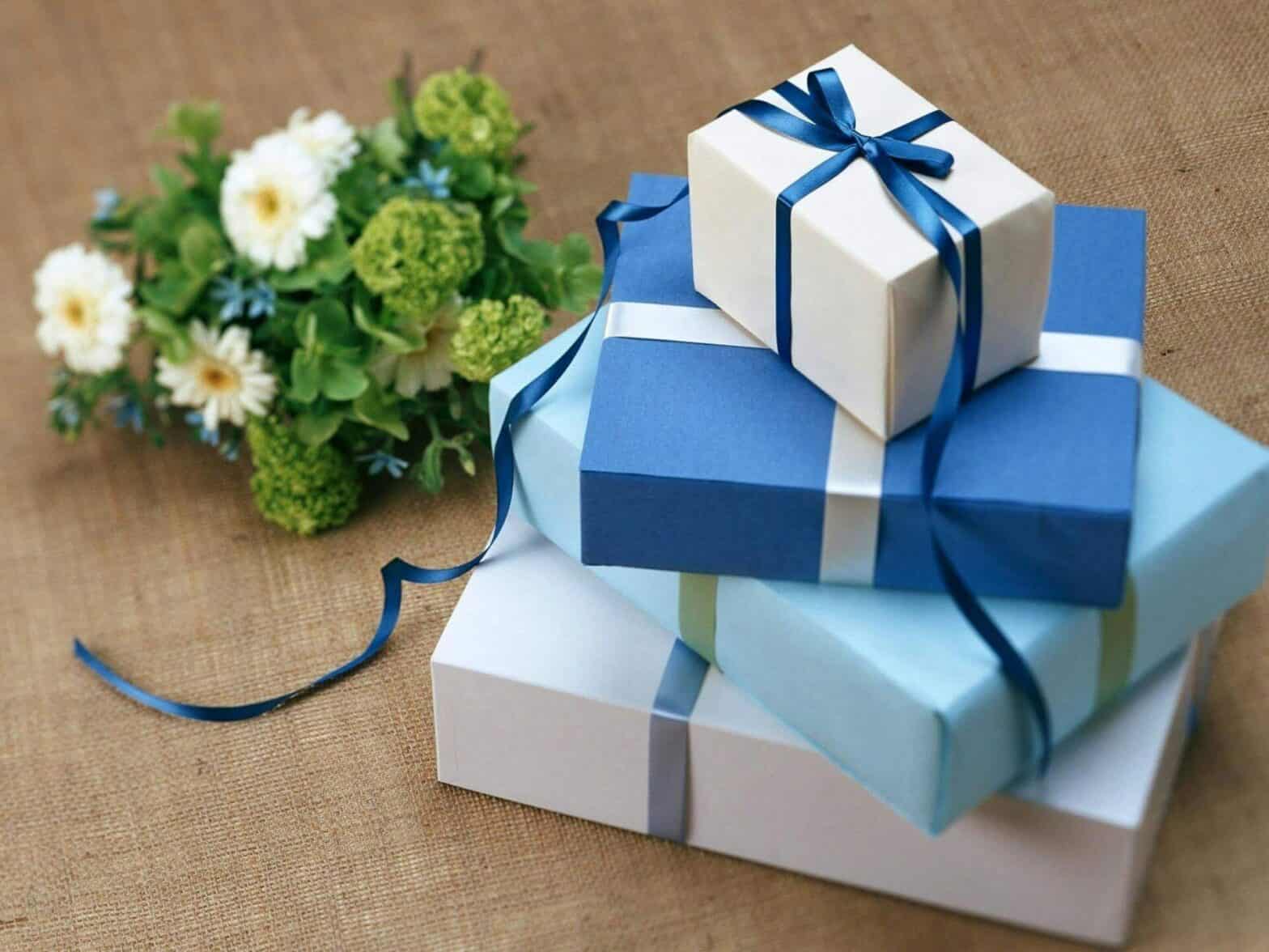 A stack of gifts and a bouquet of flowers